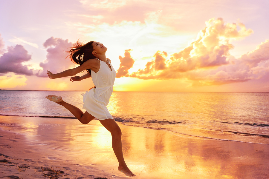 Woman feeling free and beautiful on a beach at sunset — Maison One beauty salon, Clontarf Dublin